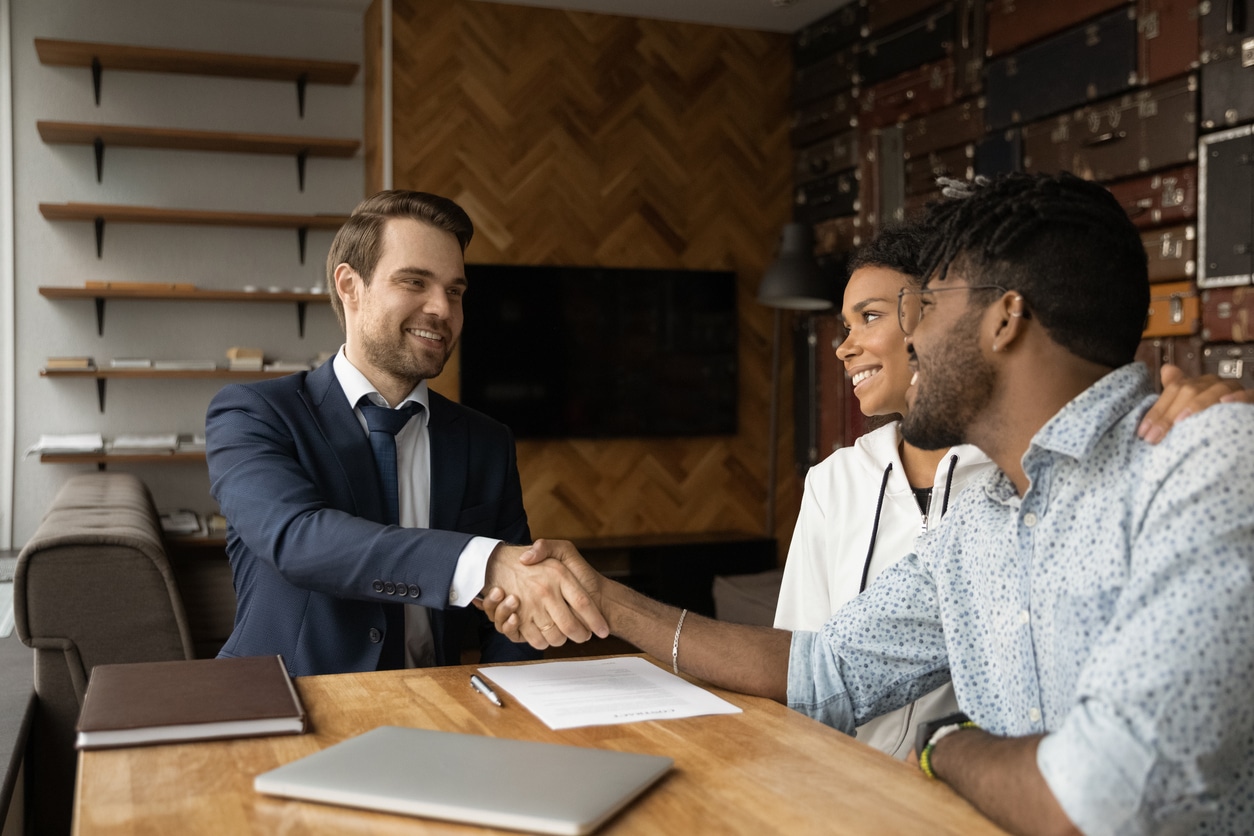 Family shaking hands with their attorney after signing a personal injury representation agreement